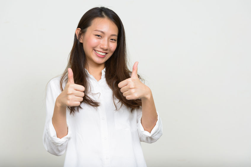Woman giving thumbs up, signifying she is happy with her choice