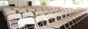 rows of folding chairs set up for guests, created with generative ai