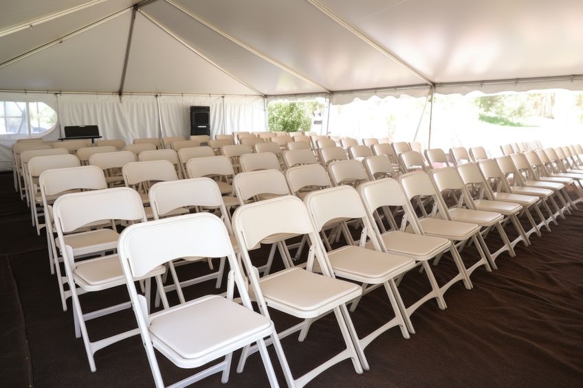 rows of folding chairs set up for guests, created with generative ai