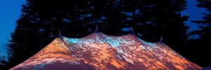 Wedding reception at night under wedding tent